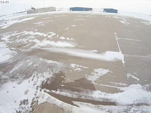 Driver loses control on icy airfield lot