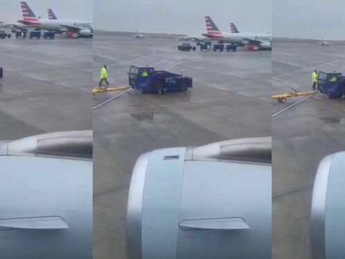 Worker tries to tow a truck stuck in the snow