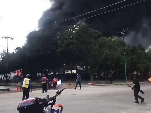 Firefighters battle intense blaze in chaotic street scene