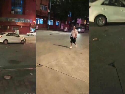 Man kicks the wheel of a car at night