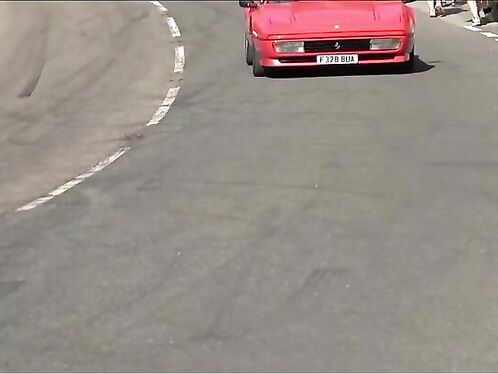 Spectators watch as a car crashes in road race