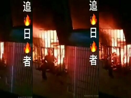 Person attempts to escape fiery structure in the night