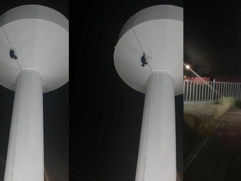 Man free falls from water tower at night