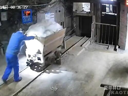 Man slips and falls while pushing a cart of snow