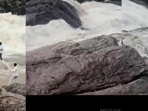 Man wades into strong waterfall current in risky stunt