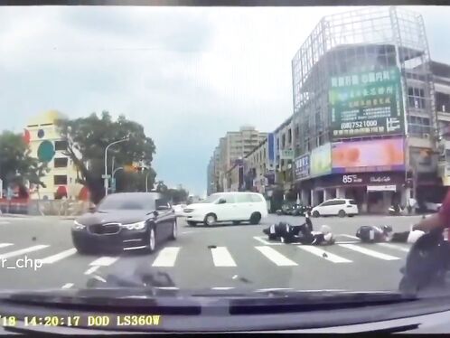 Motorcyclist takes epic dive during city intersection carnage
