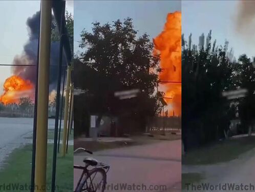 Two men run from large industrial explosion in the distance