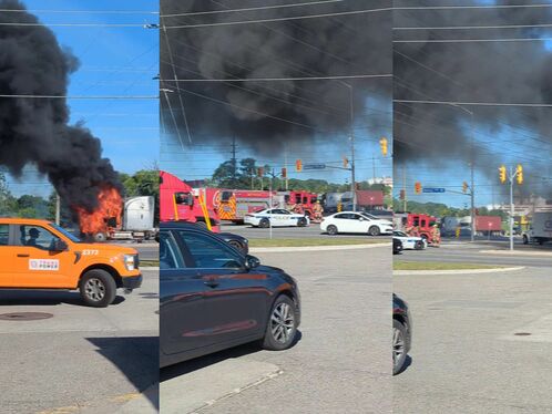 Orange truck bursts into flames at busy intersection