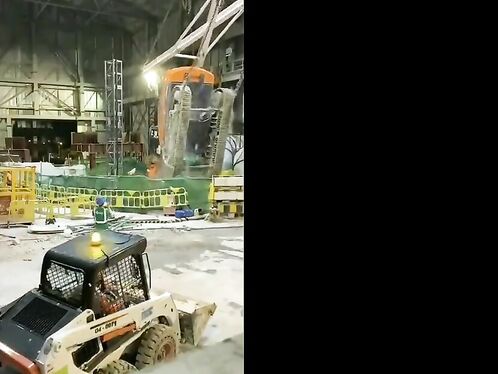 Construction crane collapses in factory, workers flee