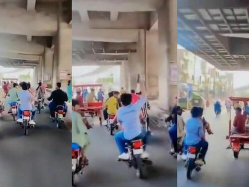 A busy street filled with motorcycles and auto rickshaws