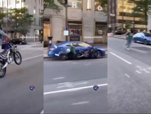 Man crashes dirtbike in middle of busy city street