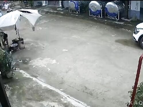 Man slips on flooded street and falls into puddle