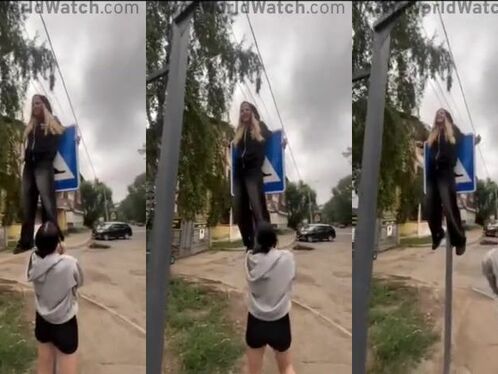 Two women accidentally knock over a pedestrian sign