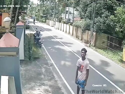 Two men walk down the road and almost get hit by a motorbike