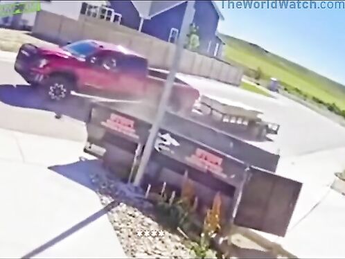Red truck crashes into metal storage containers