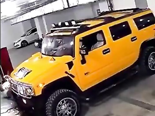 Man gets punched while exiting a yellow Hummer