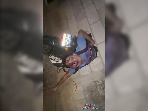 Drunk man passes out next to motorcycle on the street