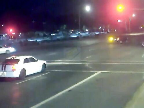 Car drifts dangerously on busy intersection at night
