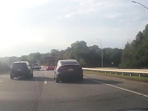Car speeds toward stalled vehicle on highway