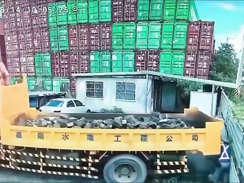 Man unloads massive truck tire by himself