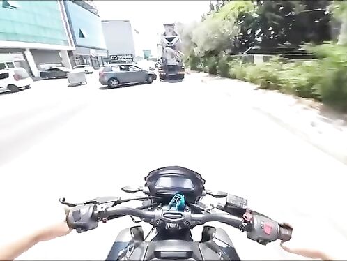 Motorcyclist crashes into truck and slides across the road
