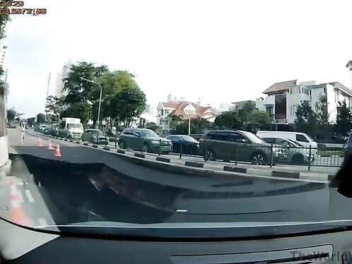 Construction worker narrowly avoids being hit by car