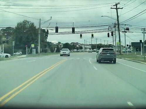 Car runs red light and causes near-miss accident