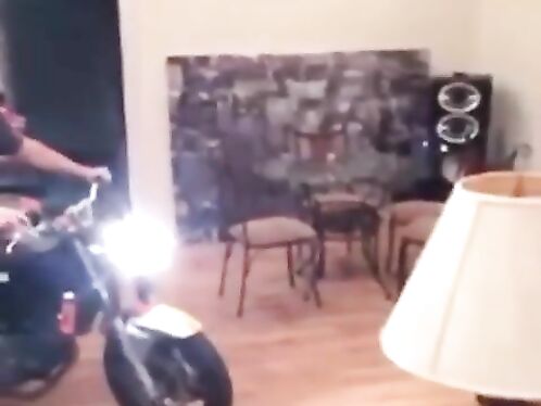 Man rides motorcycle inside living room