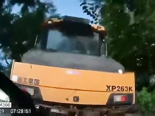 Giant truck gets stuck on narrow road and crushes car