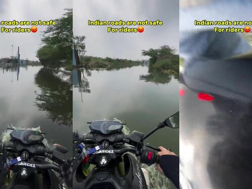 A motorcyclist splashes through flooded road