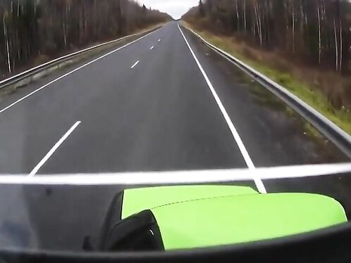 Biker speeds past semi in the fast lane