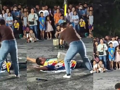 Man lies down to get cut in half by a cardboard box