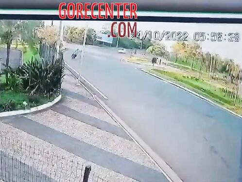 Bystanders surround fallen motorcyclist after crash