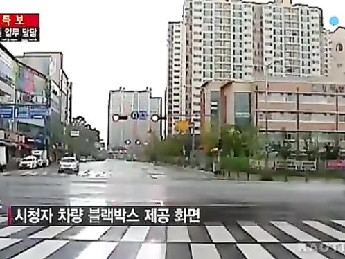 A car explodes in an urban street intersection, massive fireball ensues