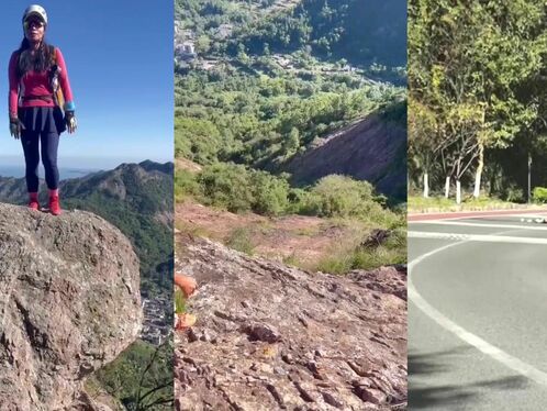 Hiker balances on massive rock in the mountains