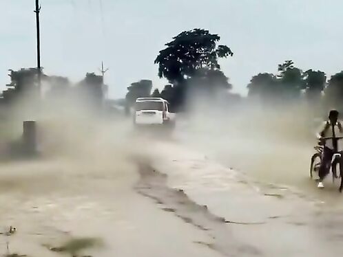 A car splashes through a flooded road