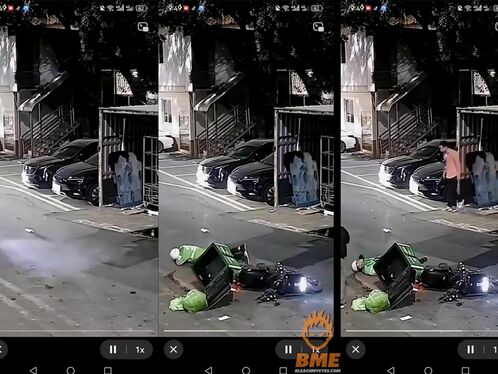 Man examines wreckage after motorcycle crash on street