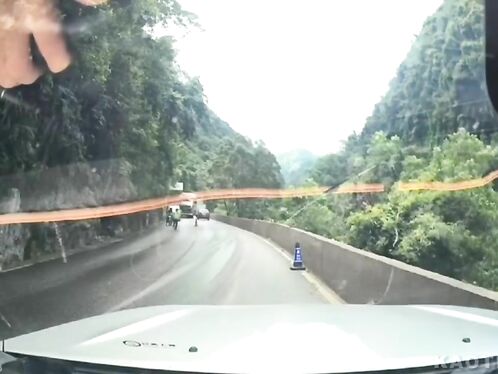 Bus blows smoke on winding mountain road