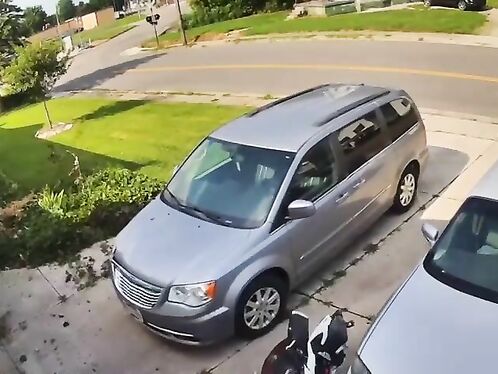Man tries to retrieve golf ball from under minivan