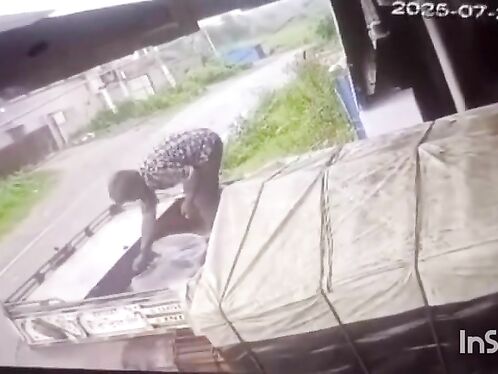 Thief struggles to lift and carry a  large item