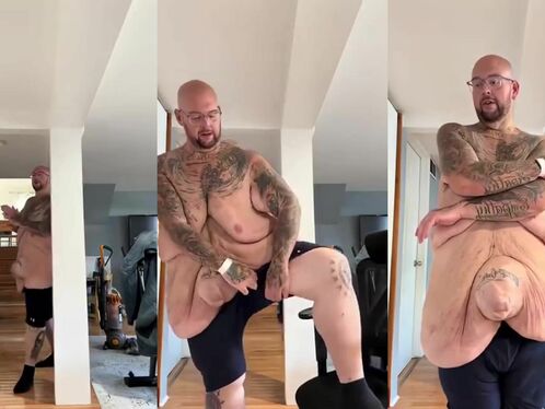 Bald man flexes his massive belly and squeezes it