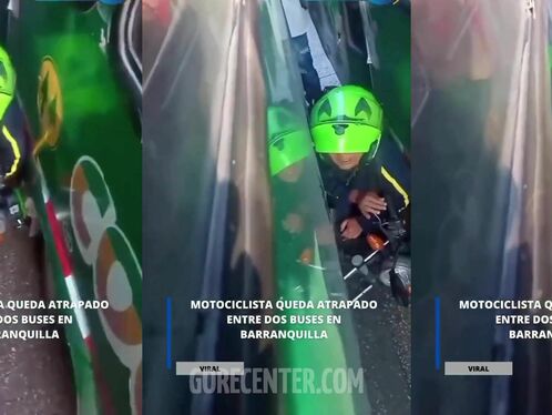 A motorcyclist gets stuck between two buses