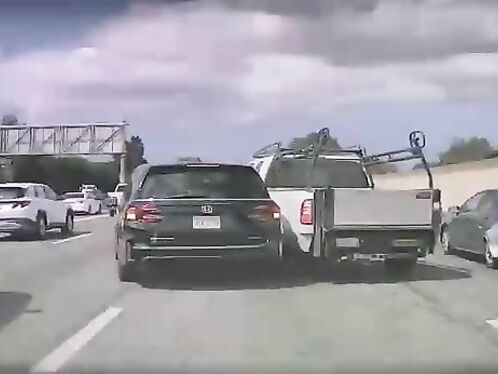 SUV pulls into truck trailer on highway
